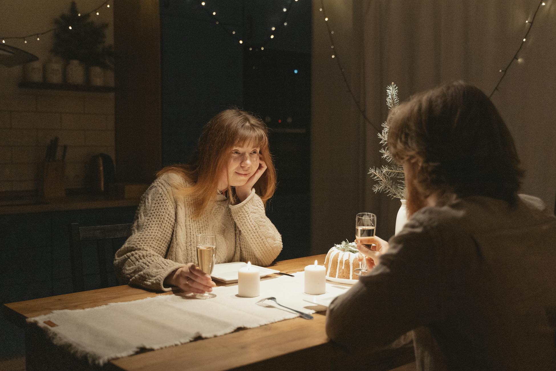 A cozy candlelit dinner scene with a couple enjoying a romantic evening indoors.