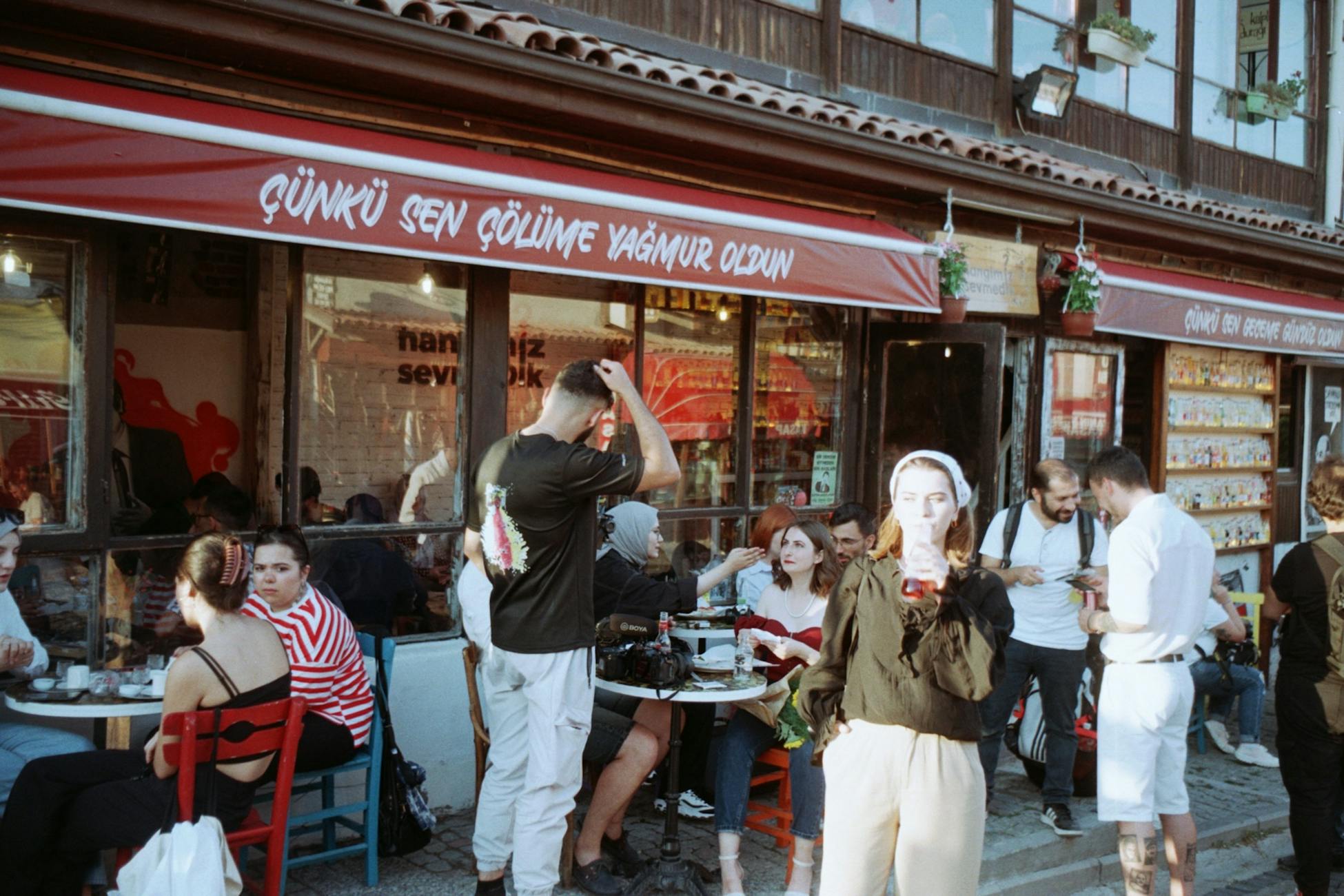 People enjoying a lively day at a bustling Turkish café.