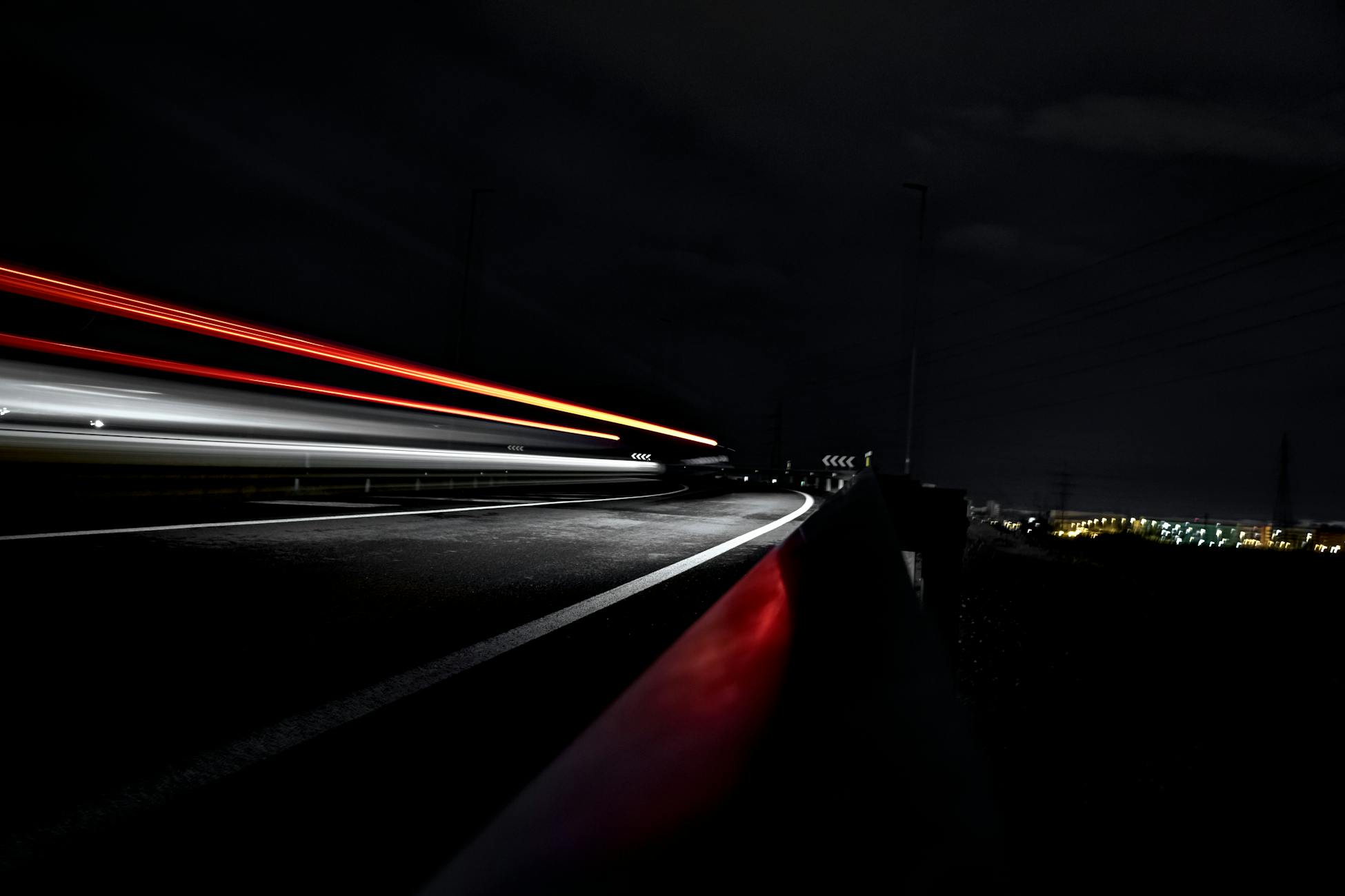 Captivating long exposure shot of light trails on a highway at night, showcasing movement and energy.