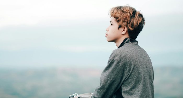 A thoughtful teenage boy gazes into the distance in Northern Mindanao, Philippines.