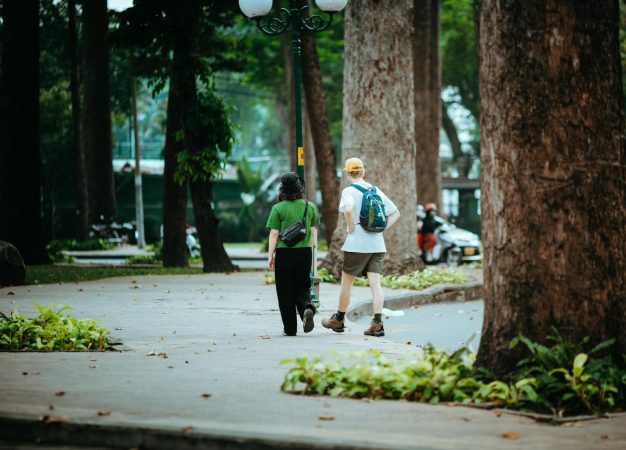 Casual stroll in a lush park in Ho Chi Minh City, Vietnam, capturing urban nature's tranquility.