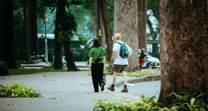 Casual stroll in a lush park in Ho Chi Minh City, Vietnam, capturing urban nature's tranquility.