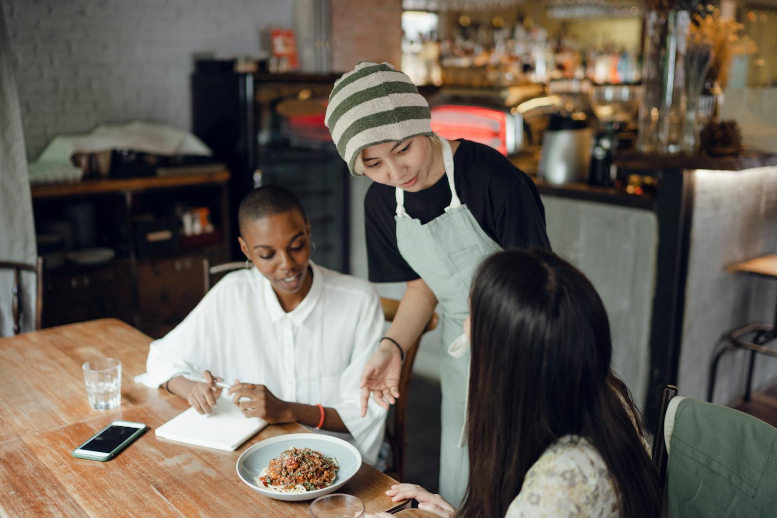 restaurant server carrying plates