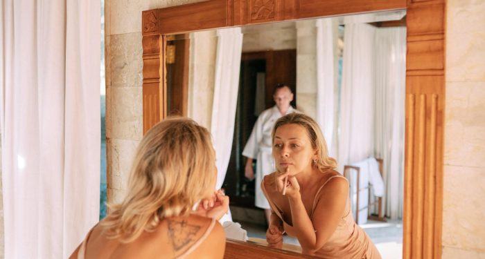 The people who seem most at ease in their bodies didn't necessarily learn to love how they look. They learned to stop narrating their appearance to themselves all day long.