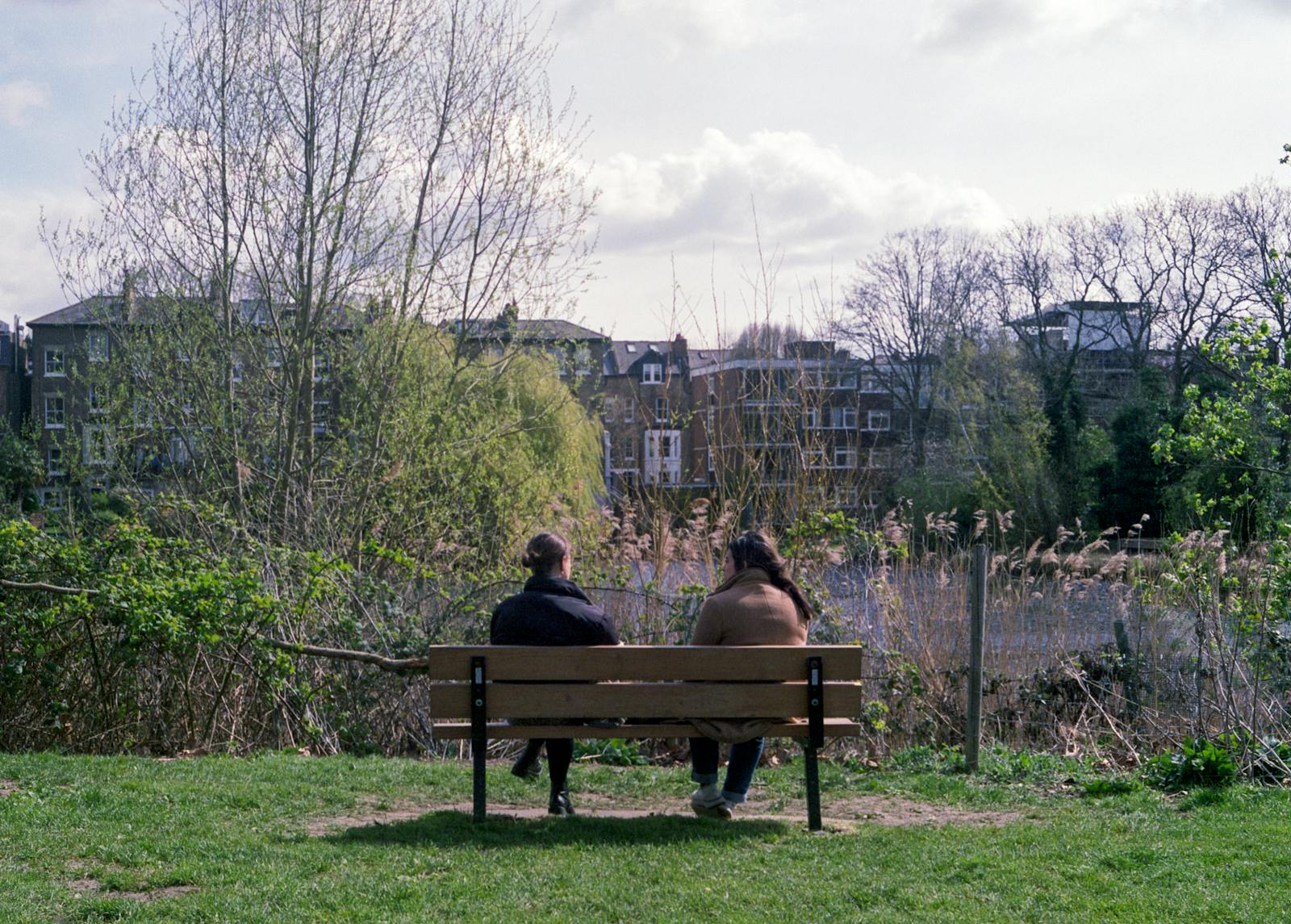 two friends quiet park bench