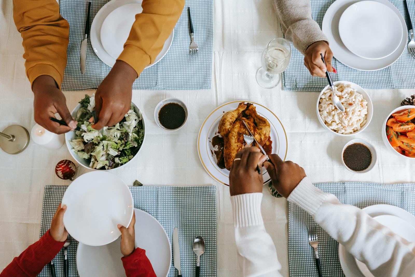 family hands passing food