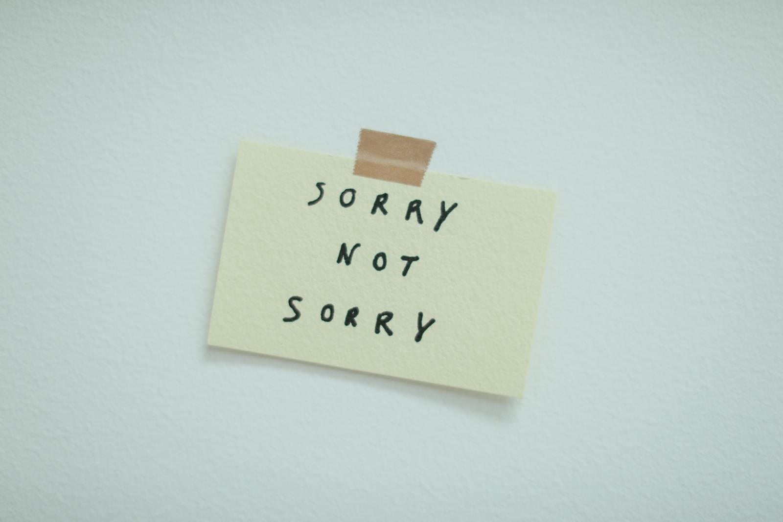 hands writing apology note