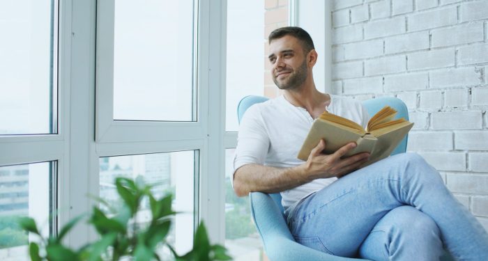 person reading alone window