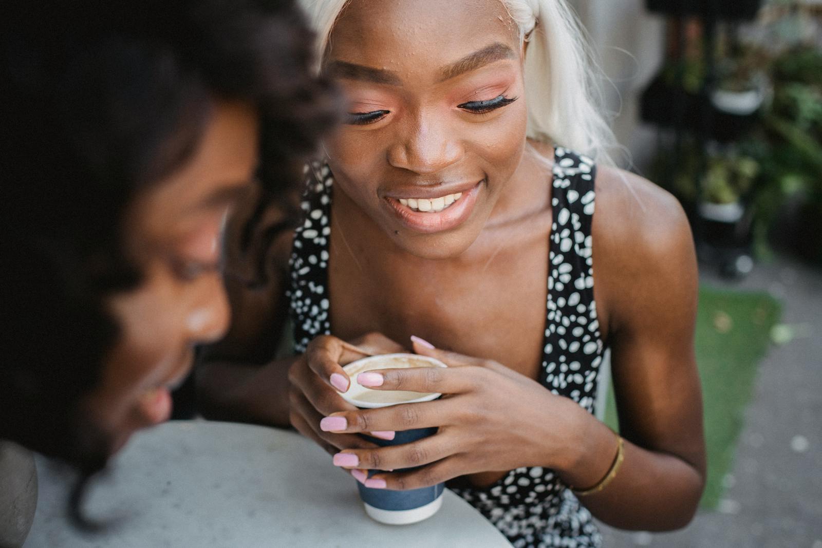 two friends laughing coffee