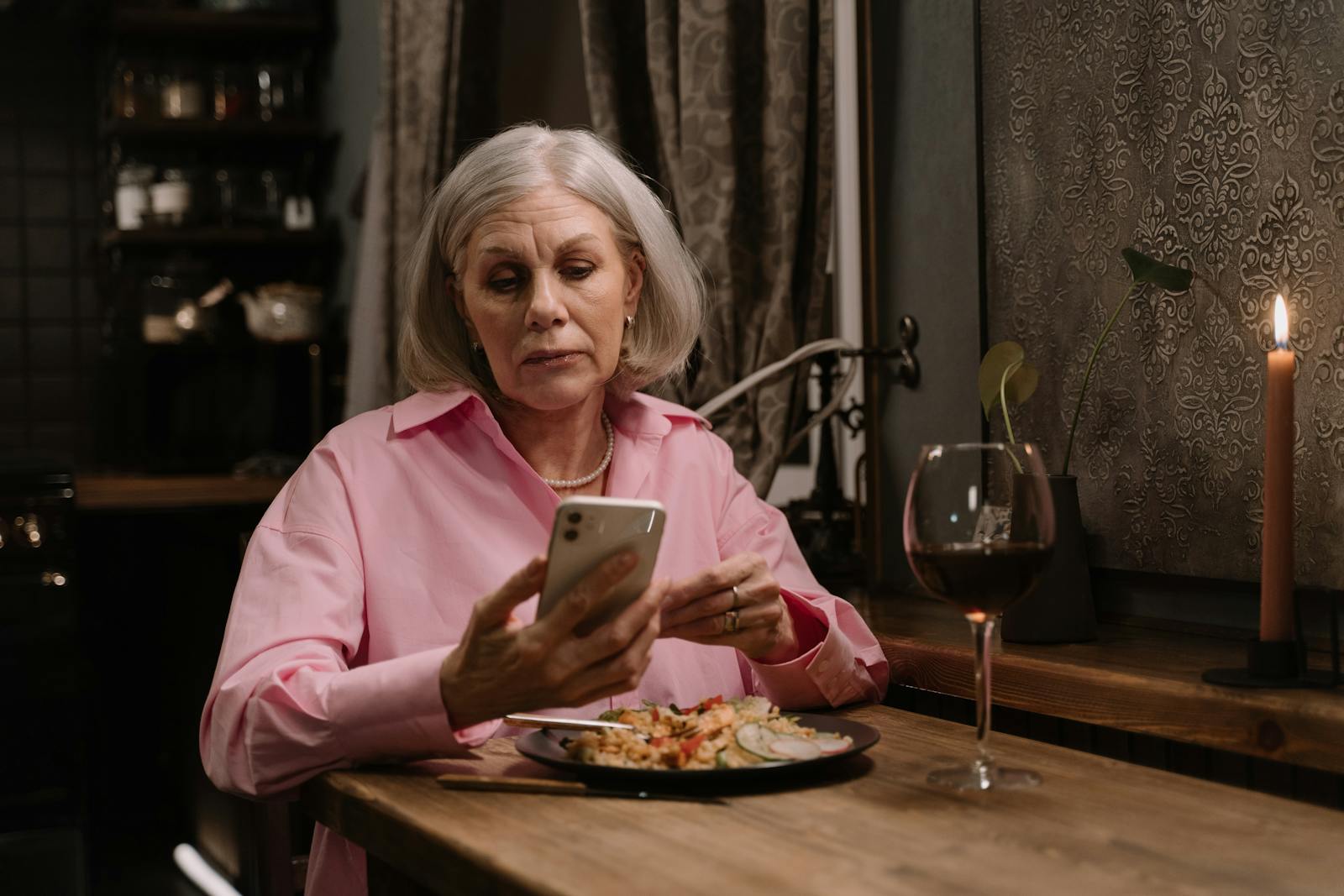 woman phone dinner candle