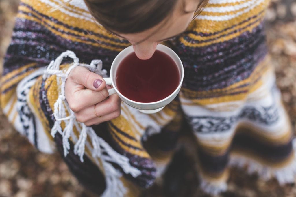 hands holding teacup
