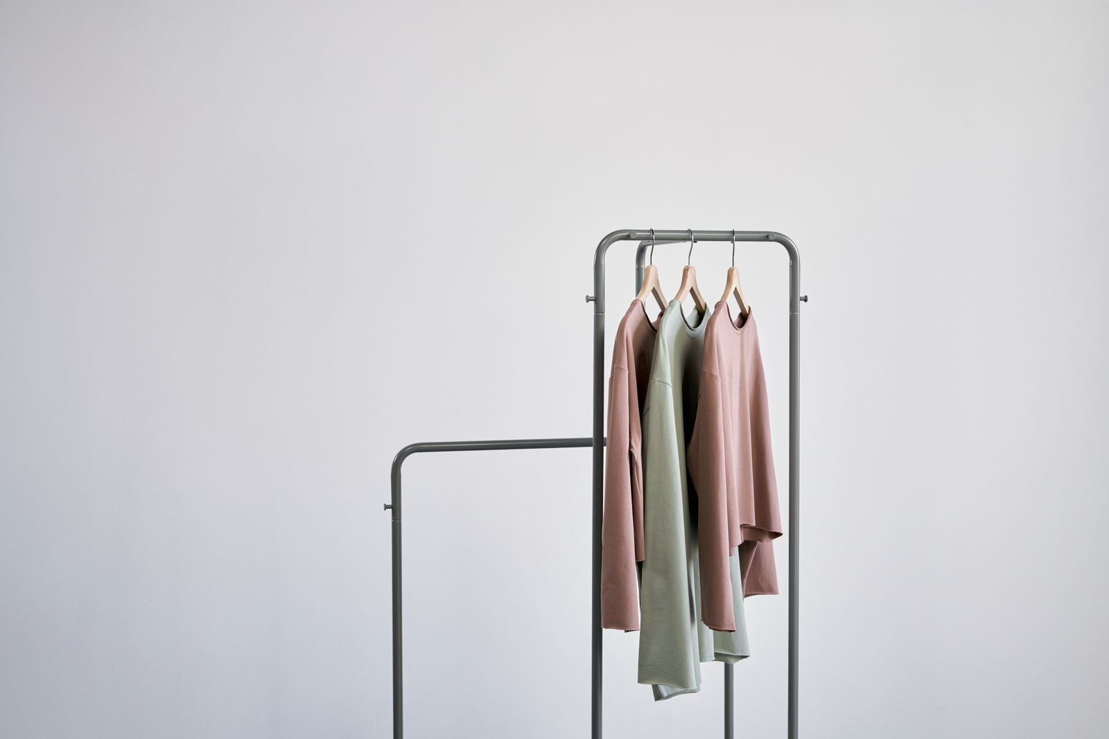 small wardrobe neutral clothes hanging