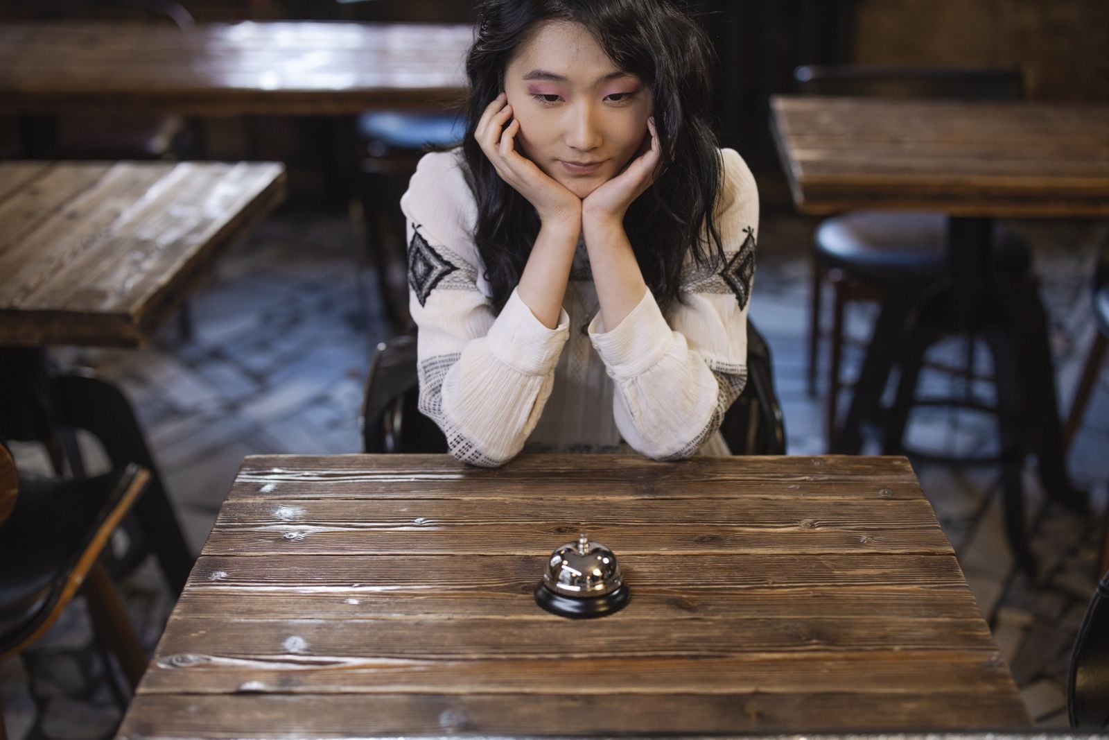 woman thinking at restaurant table